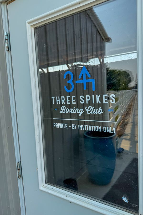 The club door sign: Three Spikes Boxing Club, private, by invitation only