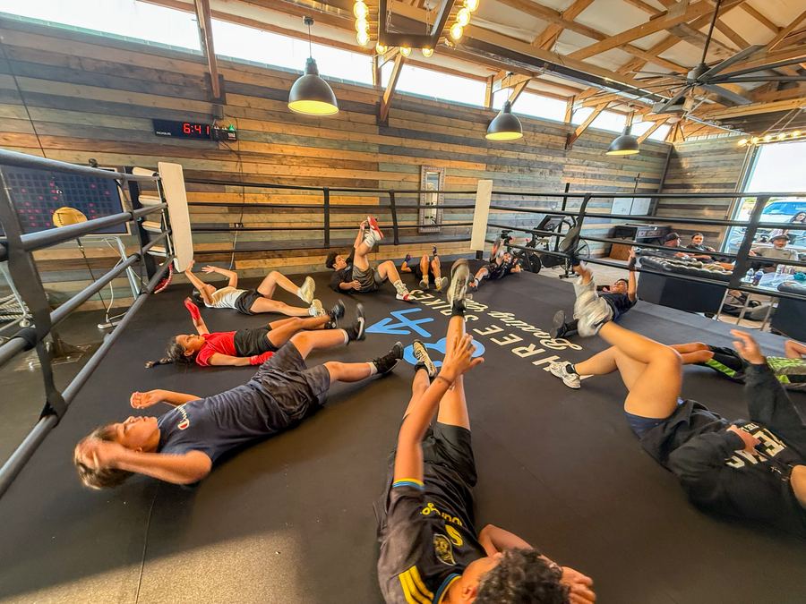 Members doing floor work on the ring mat